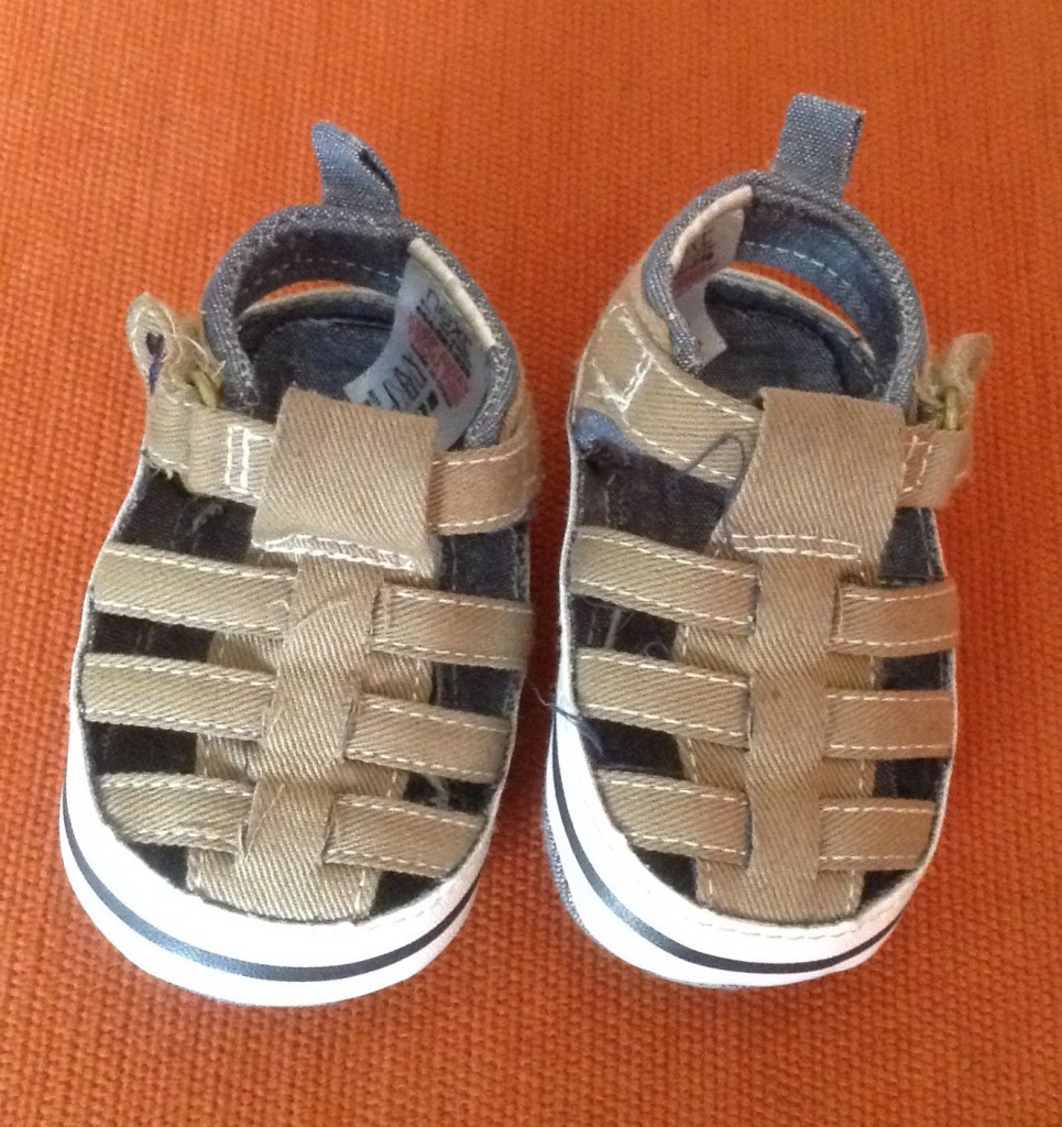 baby fashion, tan sandals on an orange background
