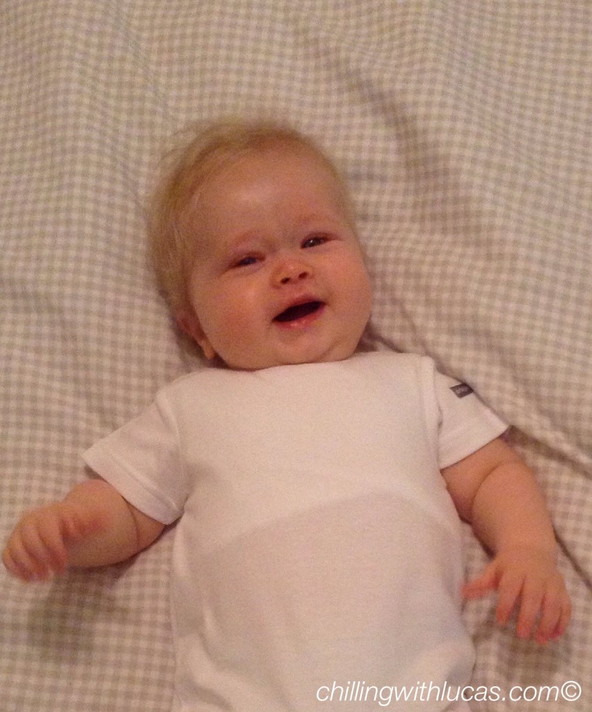 lucas led down smiling up at camera wearing a white dribblestop top