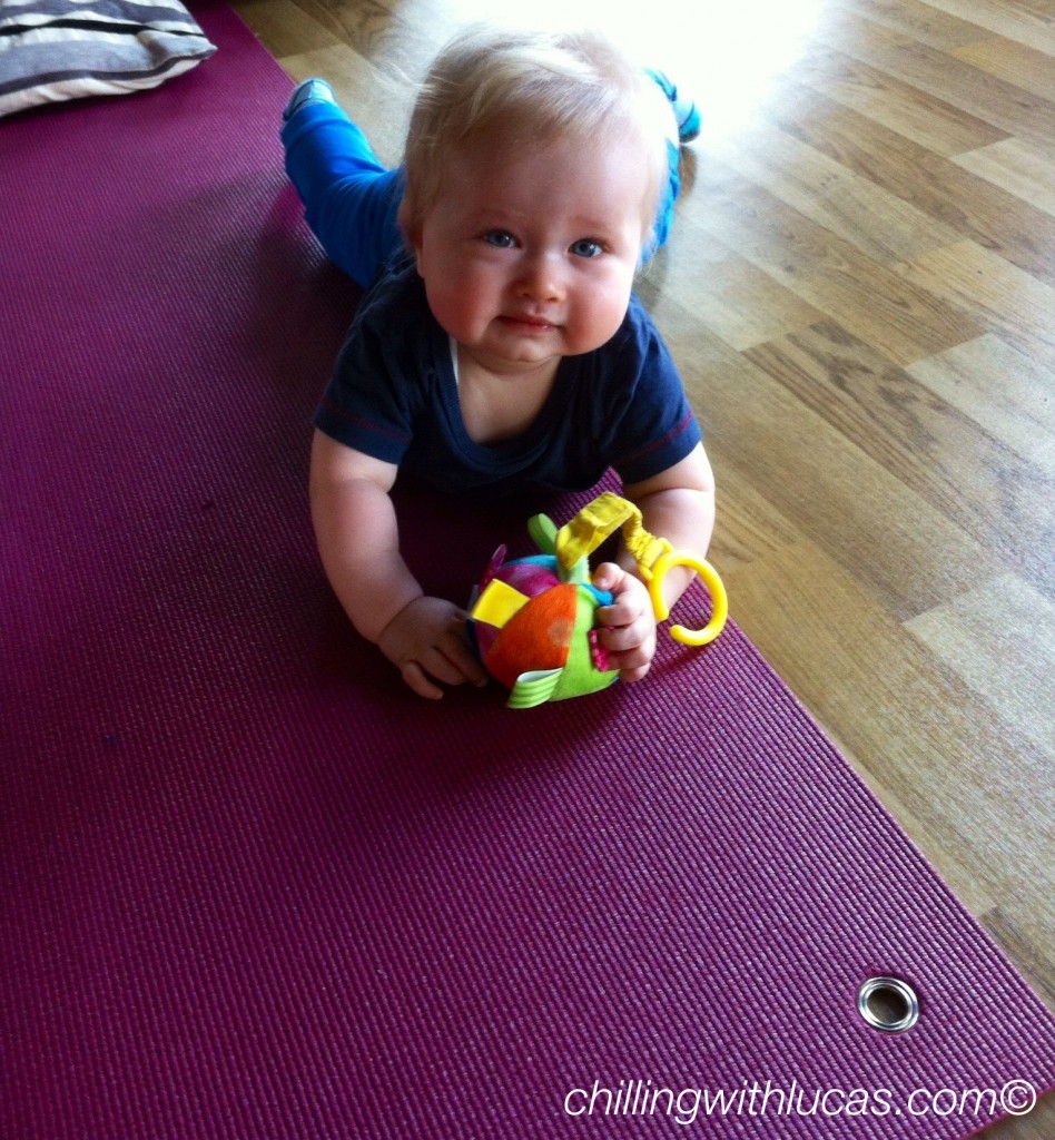 Lucas lying on a yoga mat looking up at the camera