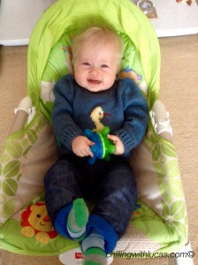 Lucas sat in his chair holding a munchkin twisty ball