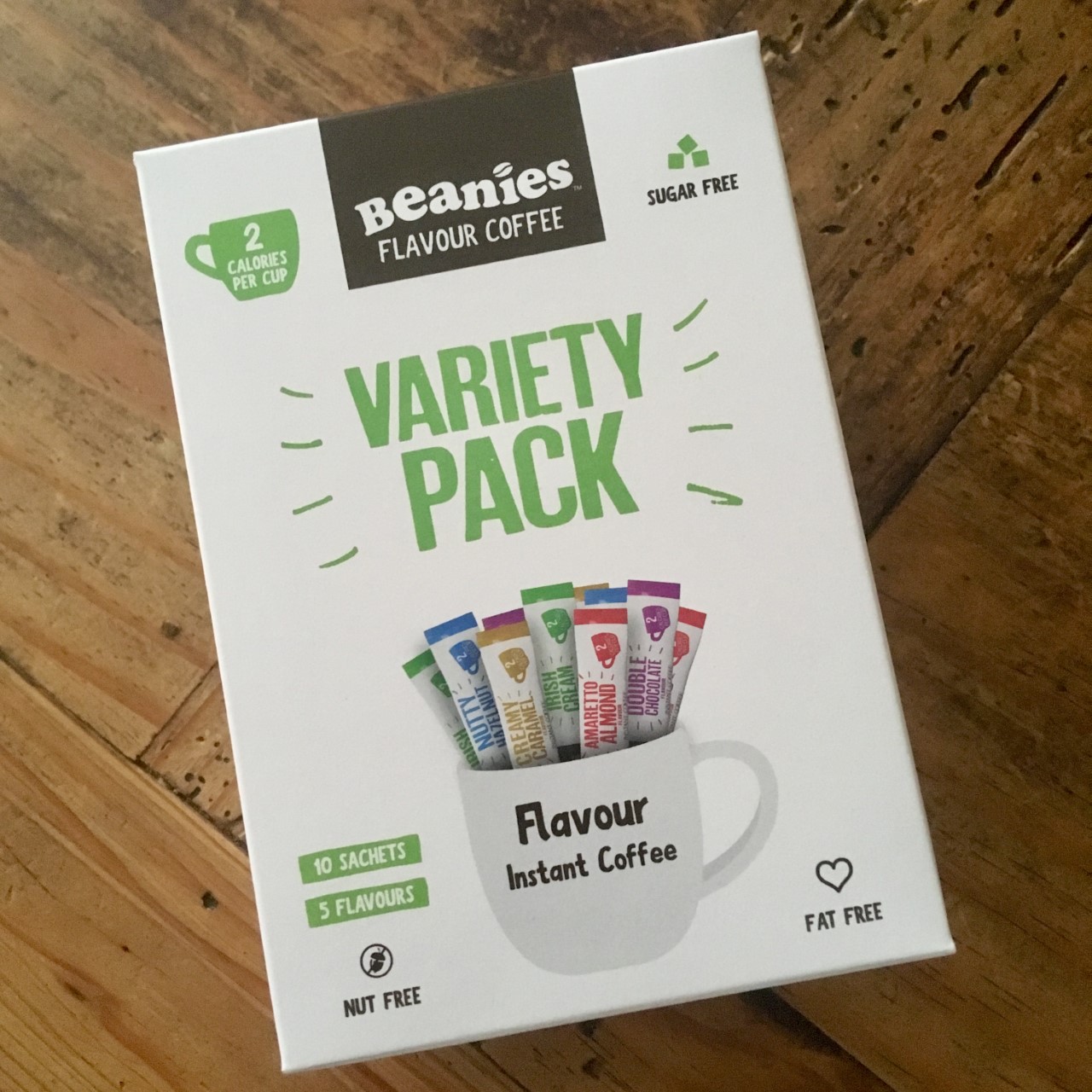 a white box of beanies coffee. The pack has a cup on it showing sachets coming out of it