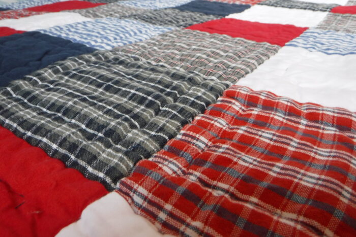 Transitioning from co-sleeping to own bedroom. babyface blue red and white patchwork quilt