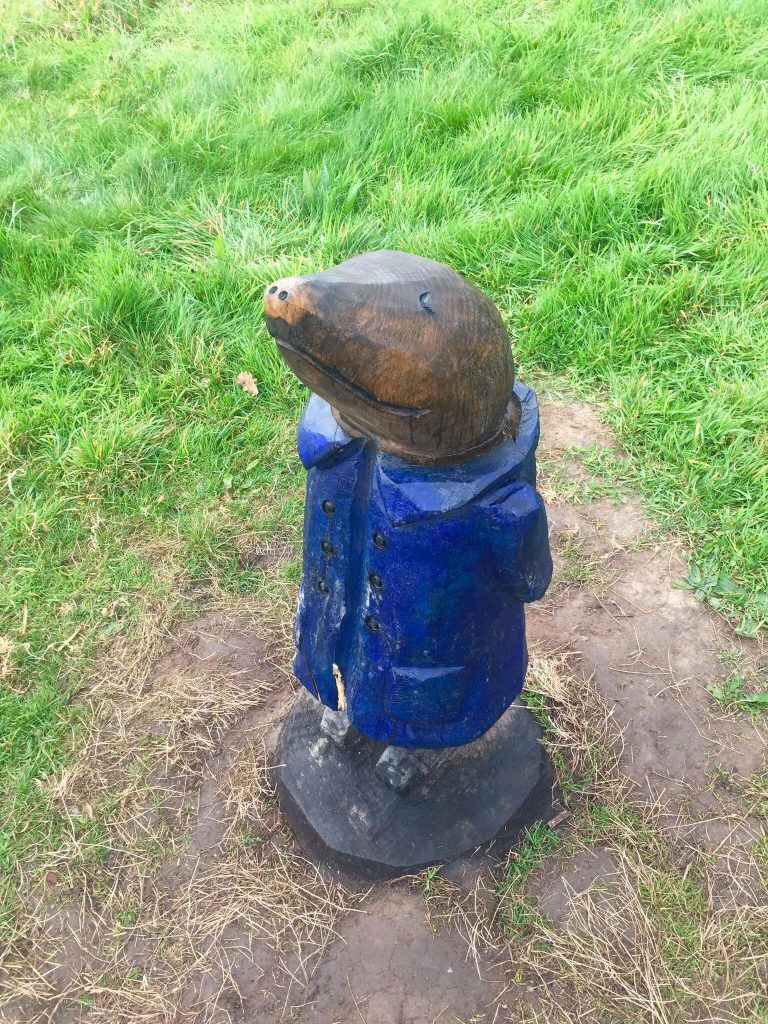 #WalkWithWynsors at Brockholes Nature Reserve, wooden statue of a mole stood up in a blue jacket