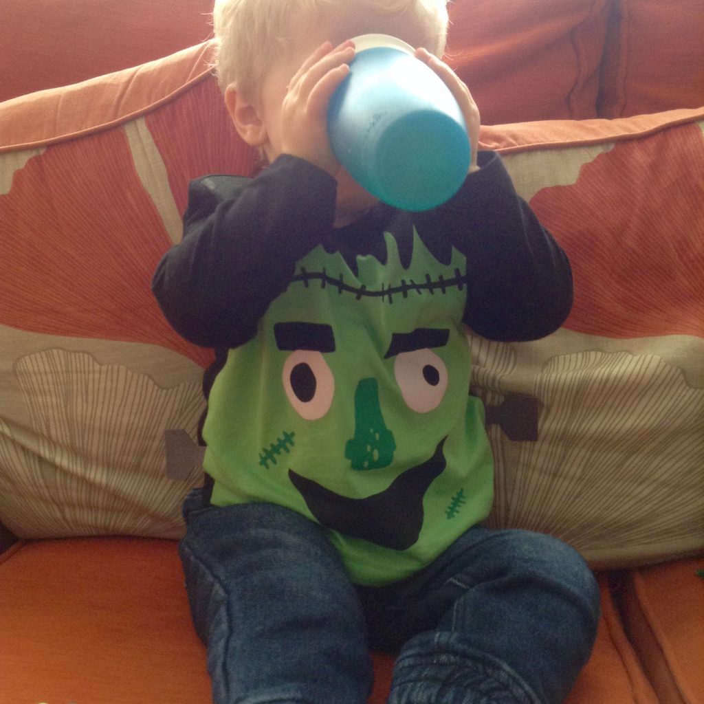 Halloween Lucas wearing a black top with a green monster on it