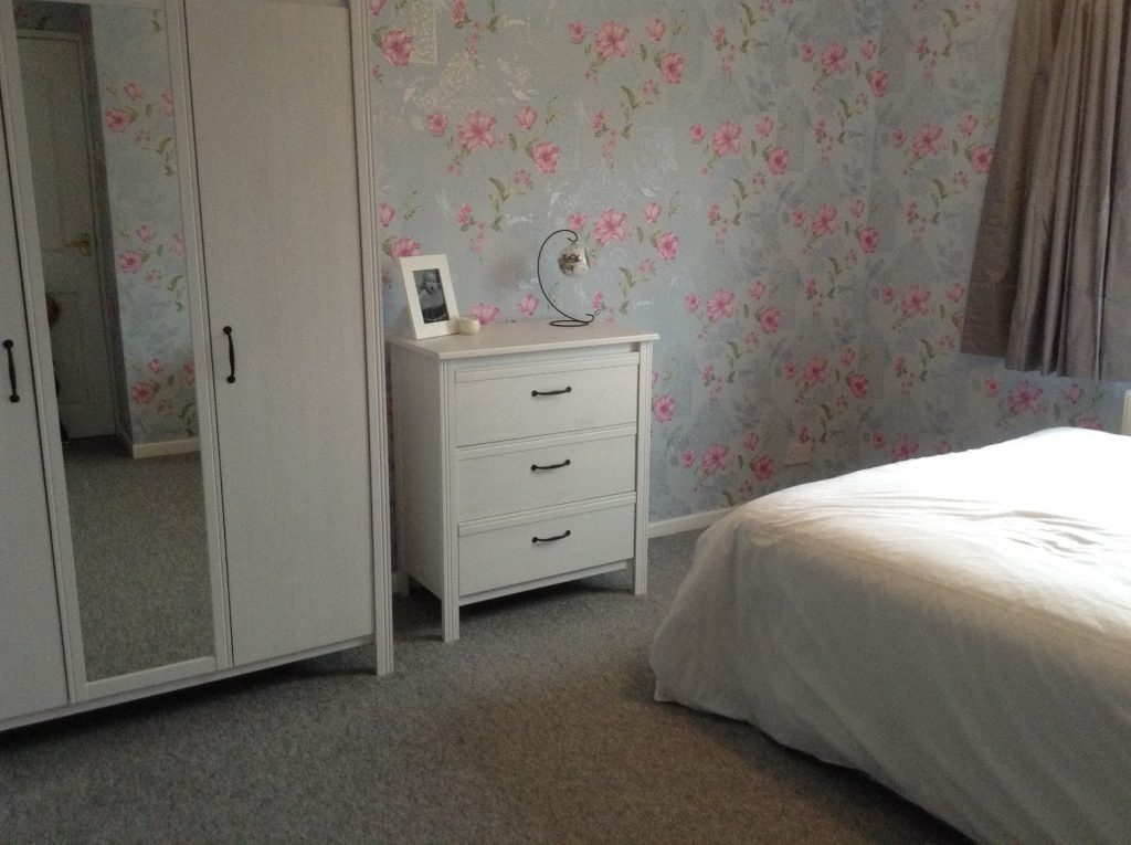 bedroom makeover, crown powder blue and cherry pink floral wallpaper with silver etched birds and glitter details, grey carpet, white ikea furniture 