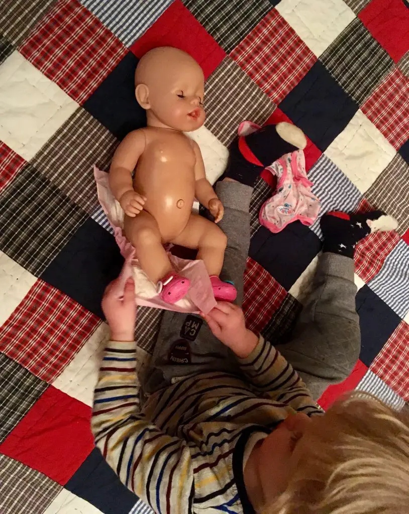 Lucas I say up over the Doll changing her nappy