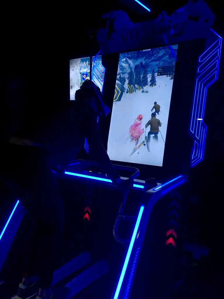 Ninja Adventure Preston review my friend is on a virtual game stood up bent forward skiing. You can see the screen in front of her that shows spectators where she thinks she is in the game