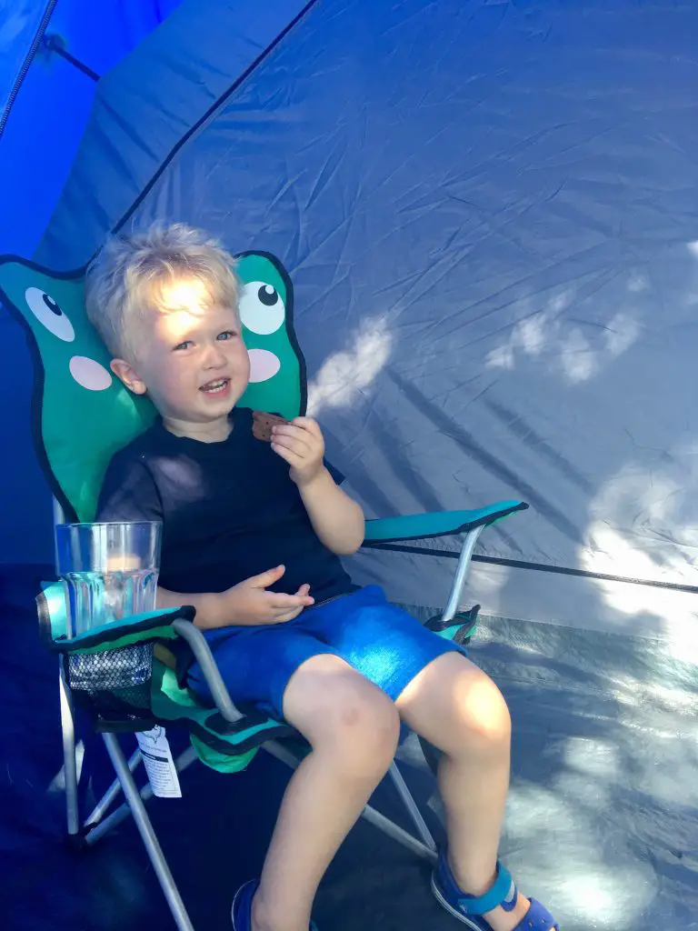Wild Night Out 2018 Lucas is sat in a children’s camping chair smiling at the camera