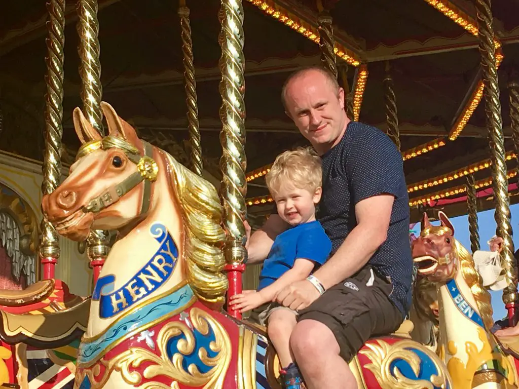 Geronimo Festival 2018 review D and Lucas looking at the camera sat on the horse merry go round