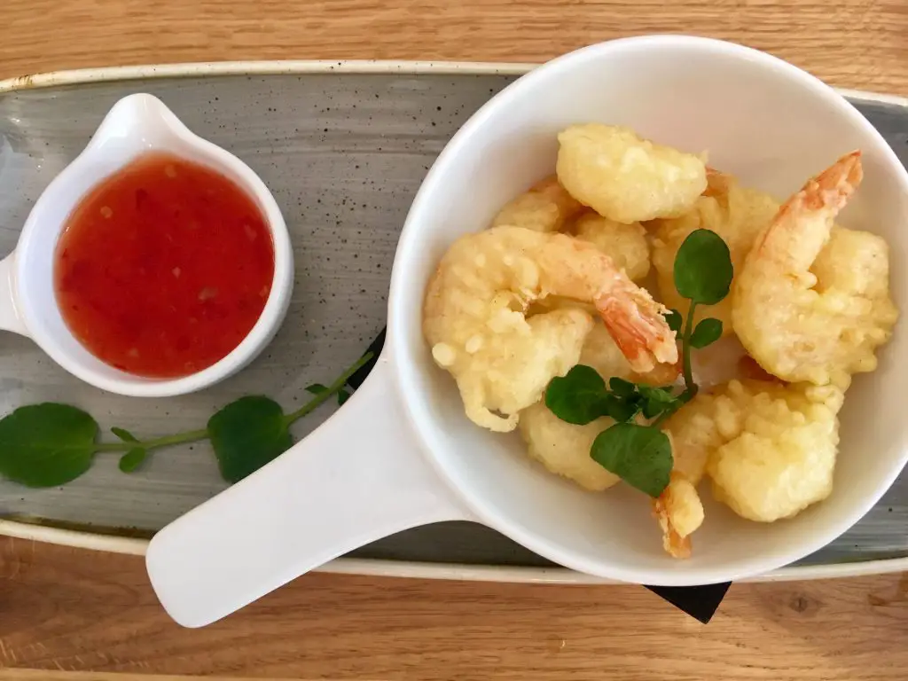 The Brasserie, Lancaster review. Prawn tempura in a white bowl and next to it sweet chilli sauce in a smaller white bowl. Both are on a long grey plate
