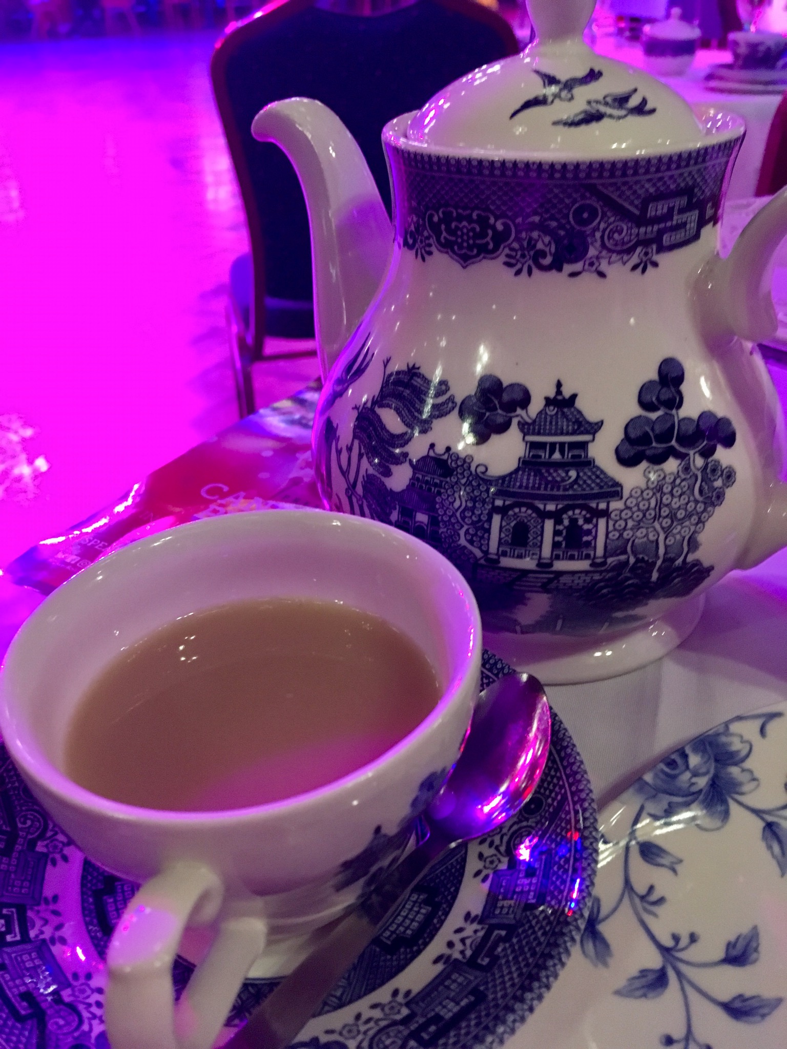 Afternoon Tea in Blackpool Tower Ballroom A tea pot and cup and saucer with tea in. The set is blue and white