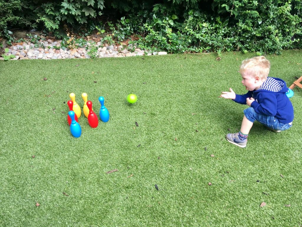 Celebrating outdoor play, every day Lucas crouching down playing Bowles 