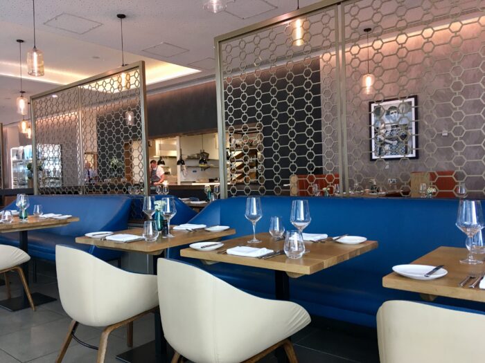 Wheelers of St. James, Liverpool review The restaurant interior. White bucket chairs with blue walls and wooden tables