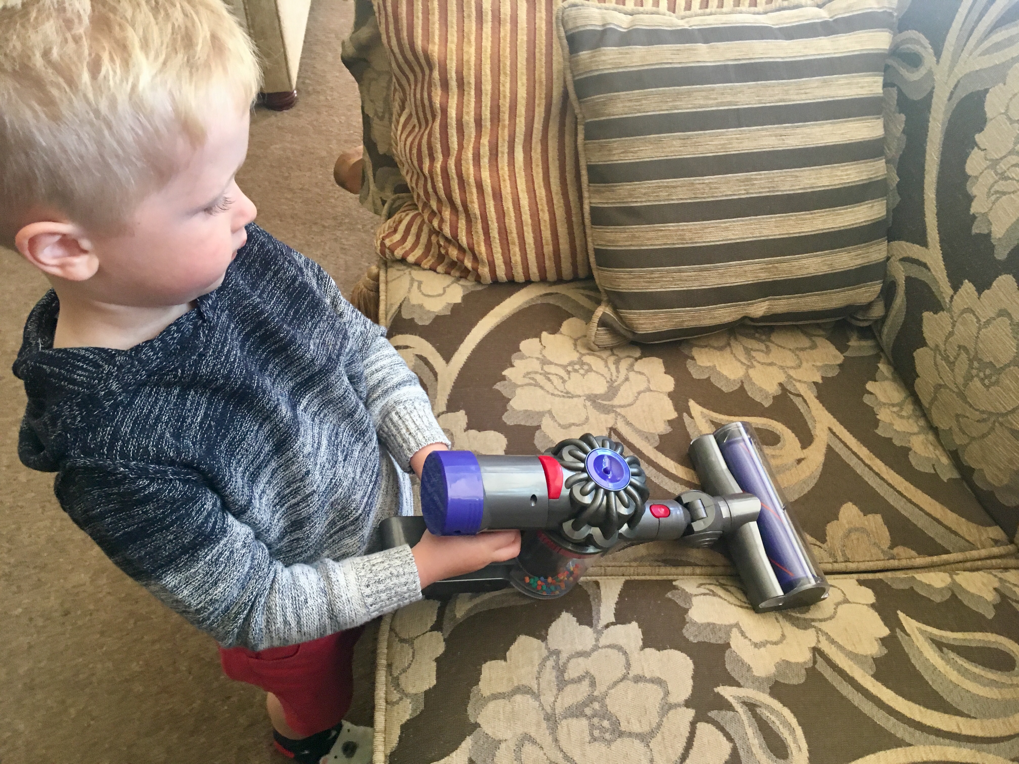 Casdon Dyson review Lucas is vacuuming the sofa