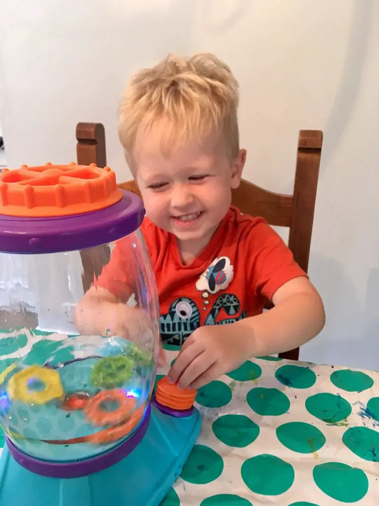 Little Tikes STEM Jr review Lucas sat at table with the tornado pressing the pump