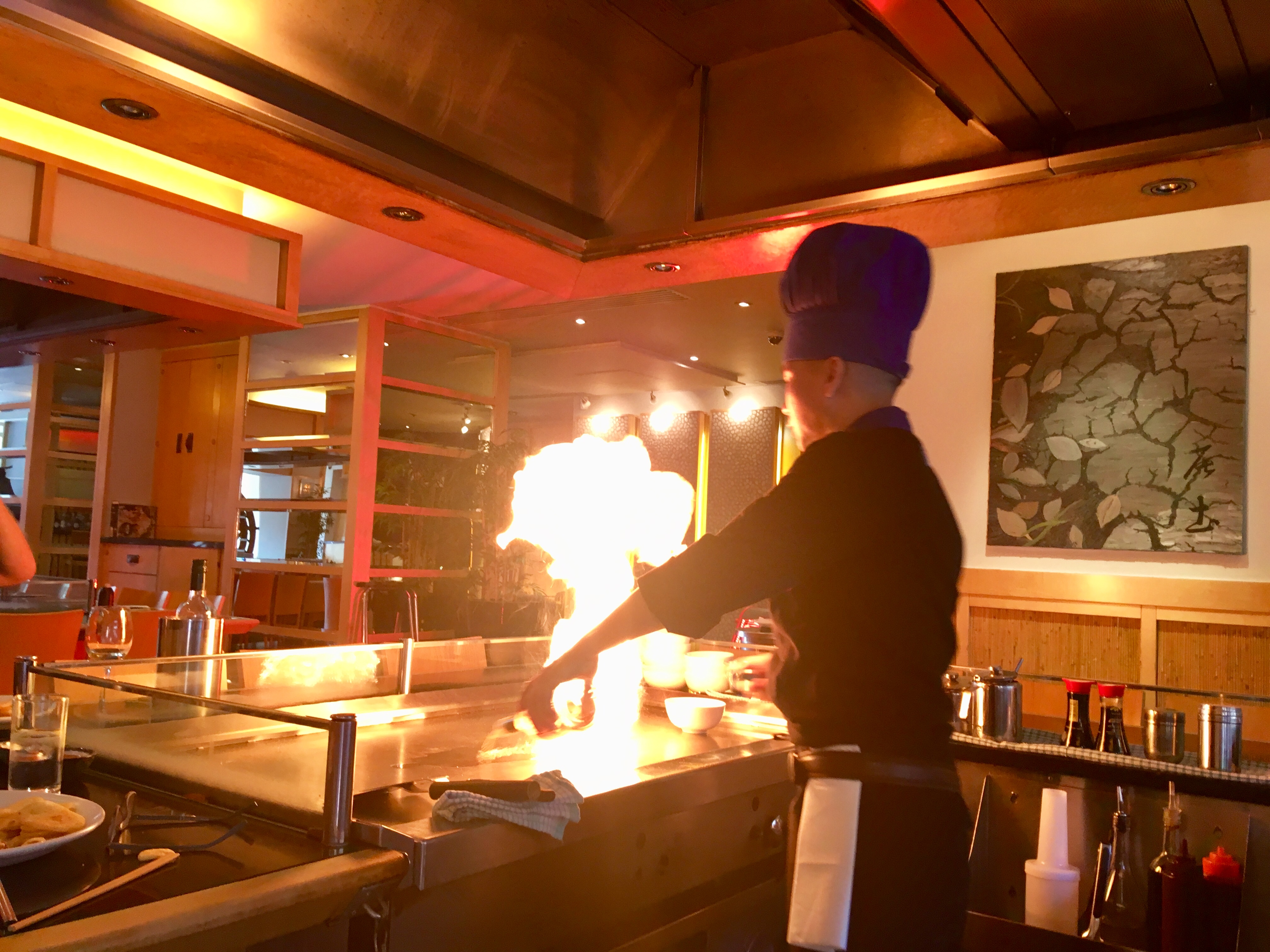 Sapporo Teppanyaki Manchester review. The chef is at the hot plate with huge orange flames