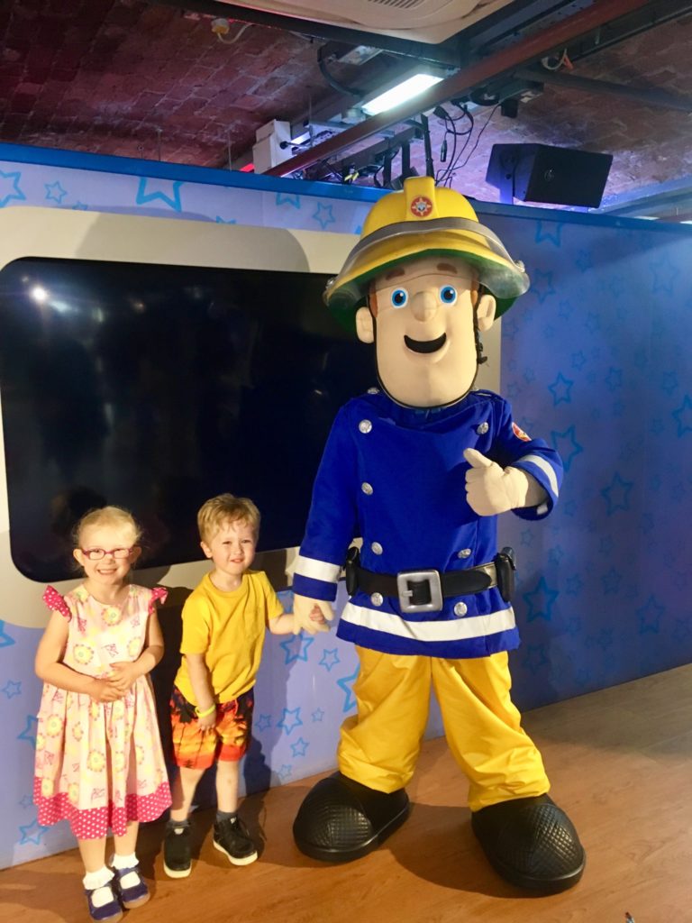 Lucas and Katie are stood next to fireman Sam 