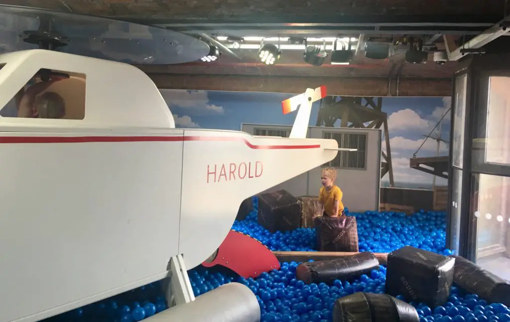 Lucas is in a blue ball pit and you can see the large Harold white helicopter in front of him 