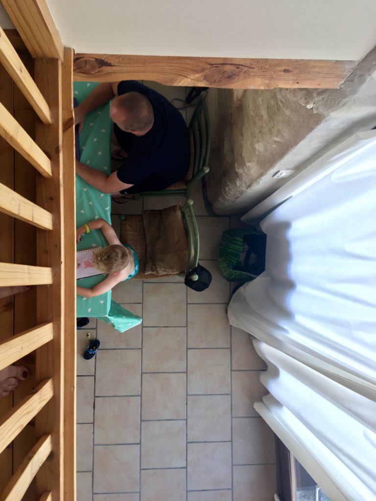 Lucas and D are sat at the table working. I have taken the photo from abover on the landing 