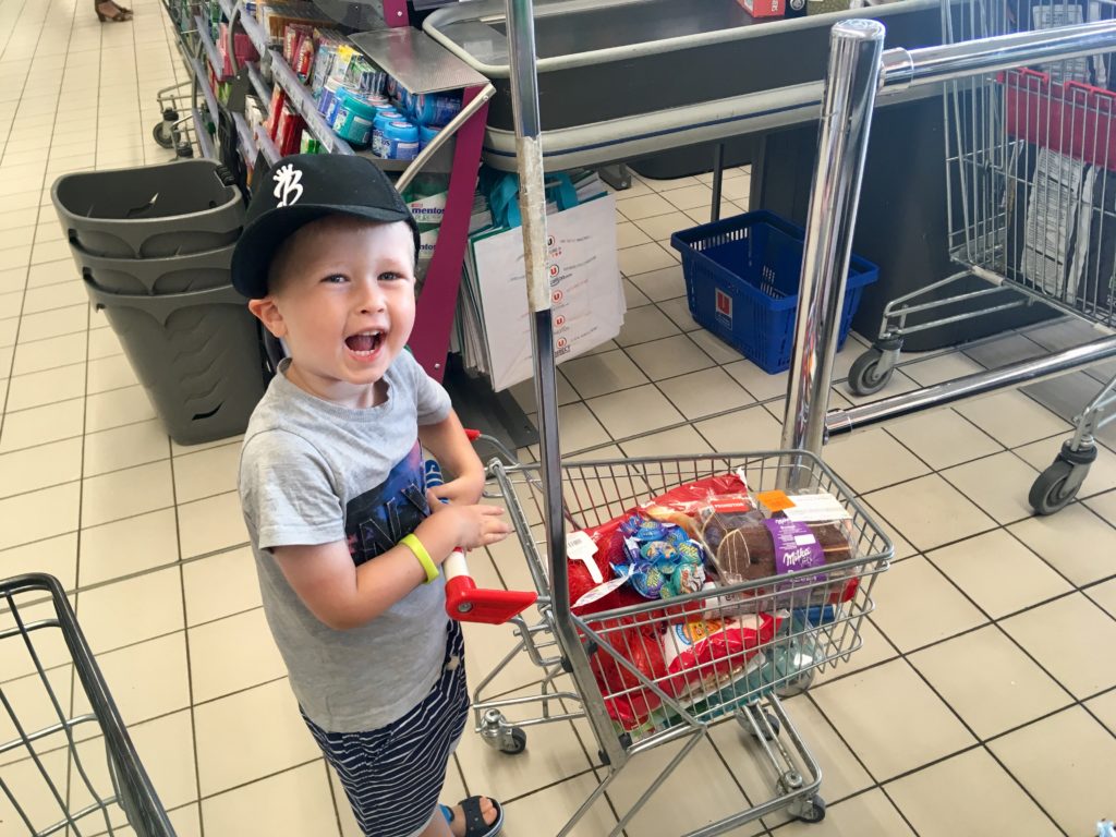 Lucas pushing a children’s trolley at supermarket