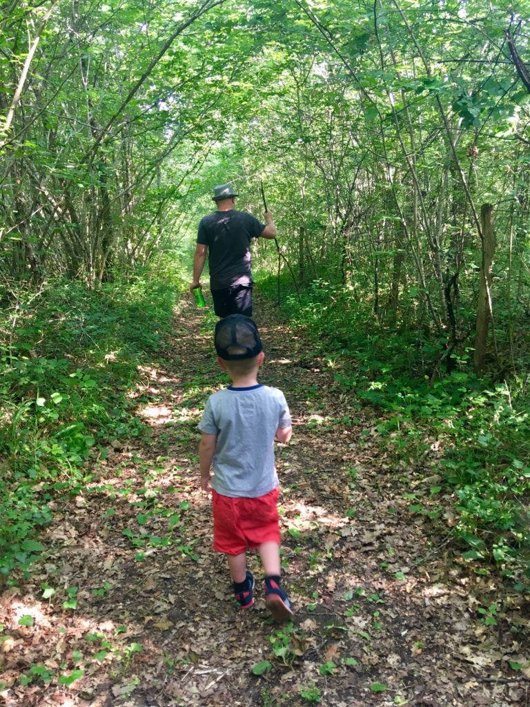 Lucas and D walking a woodland path