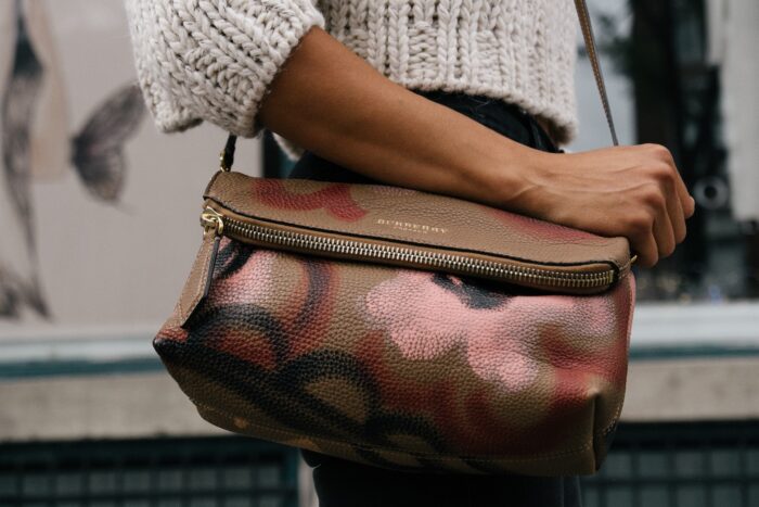 brown handbag with pink and red light shaded flowers
