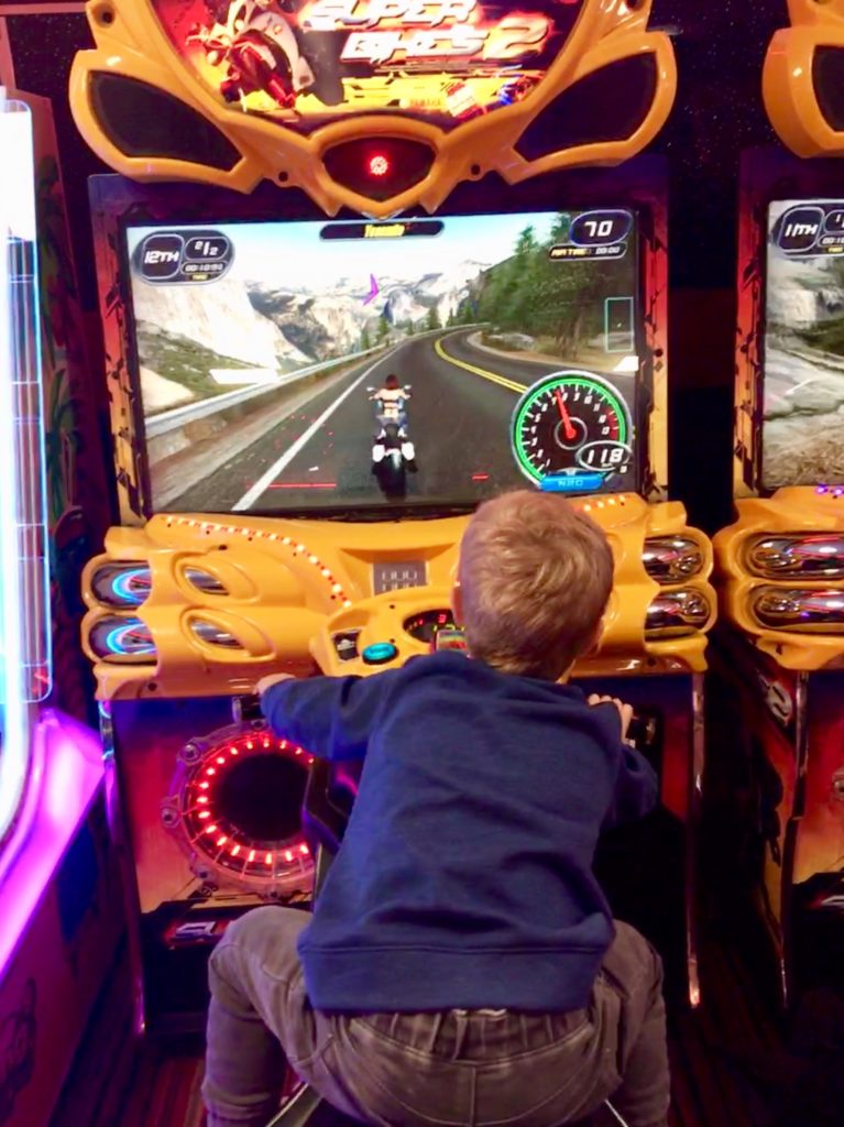 Lucas on a racing bike arcade game 