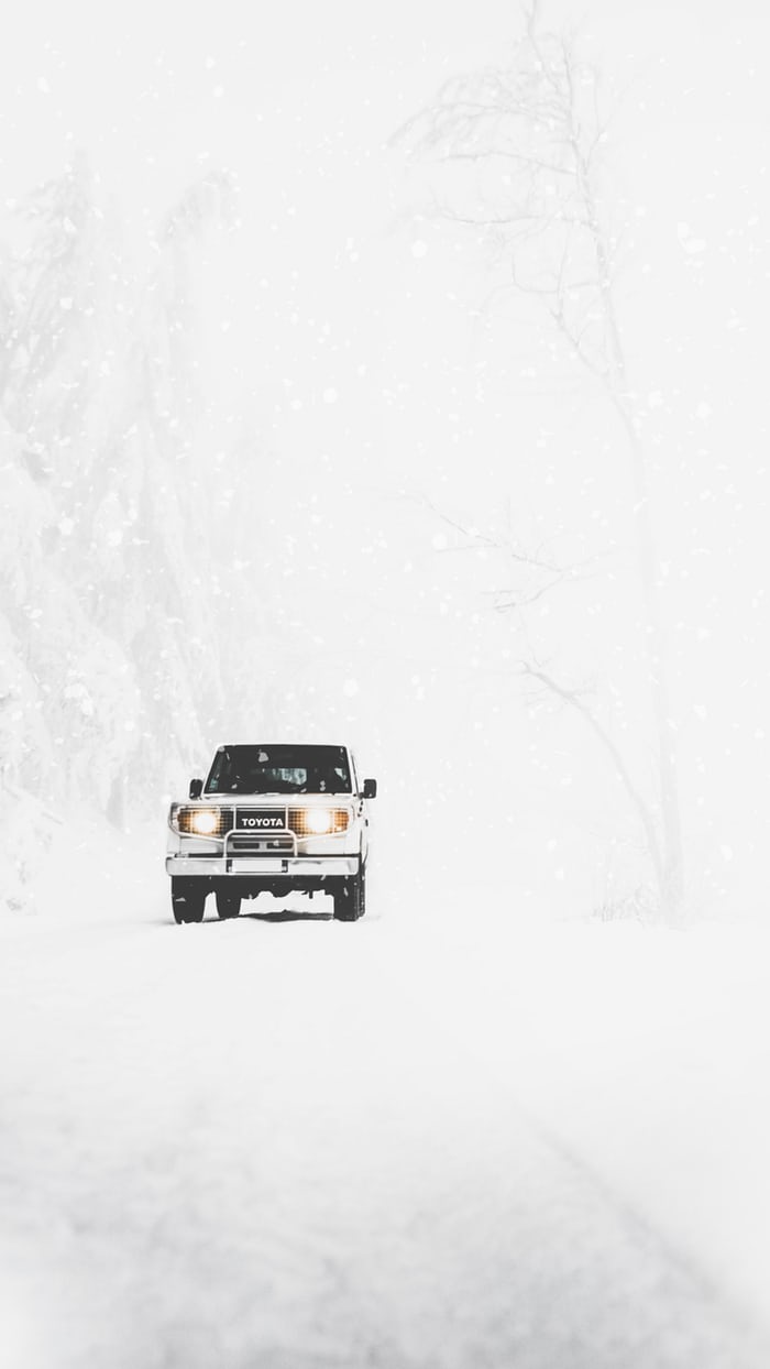 a snow filled landscape with a 4x4 car