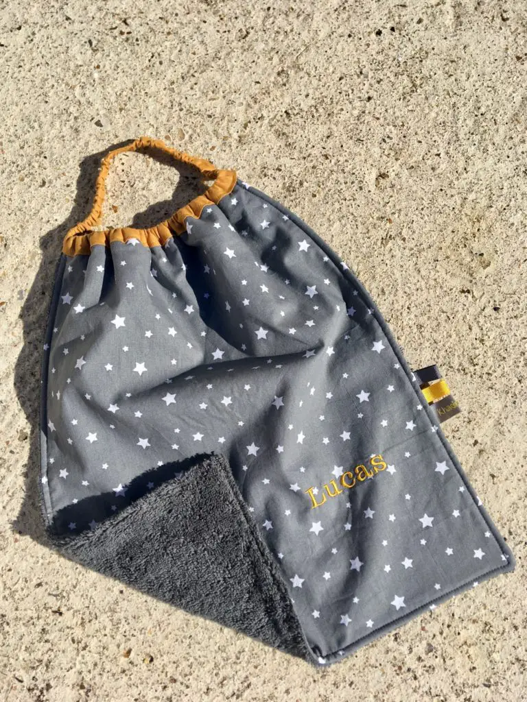 The star bib with the corner folded over showing the towelling side 