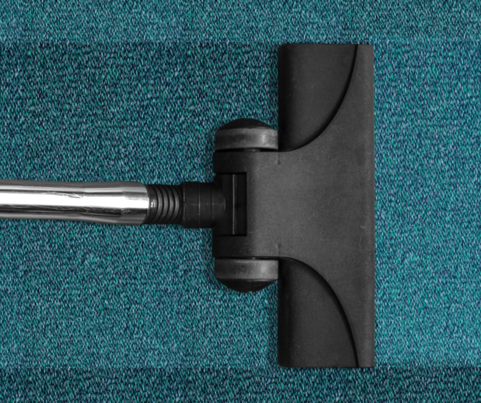 a hoover head on a teal carpet