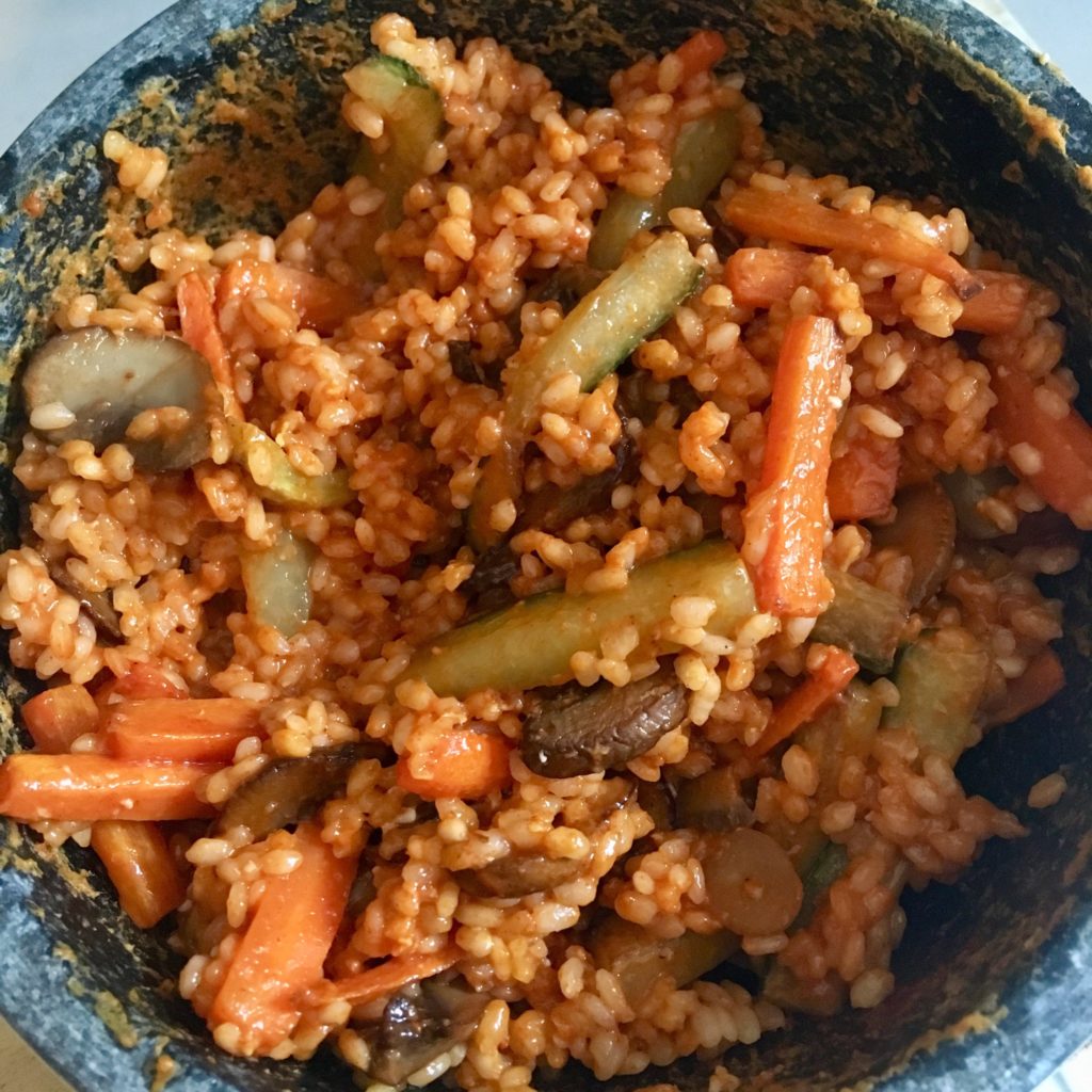 A mixed bibimbap showing the rice and veg mixed up together 