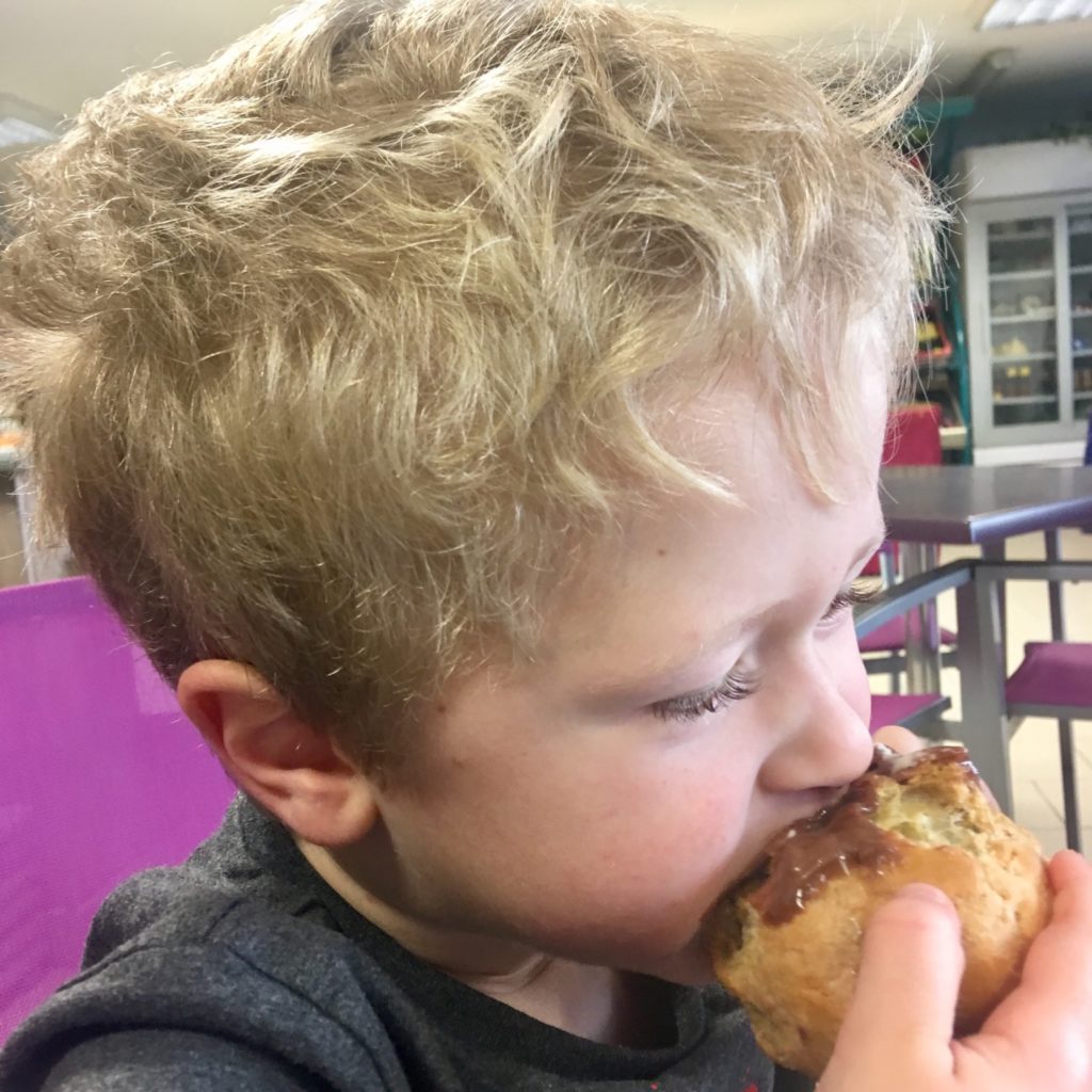 Lucas eating a cream pastry