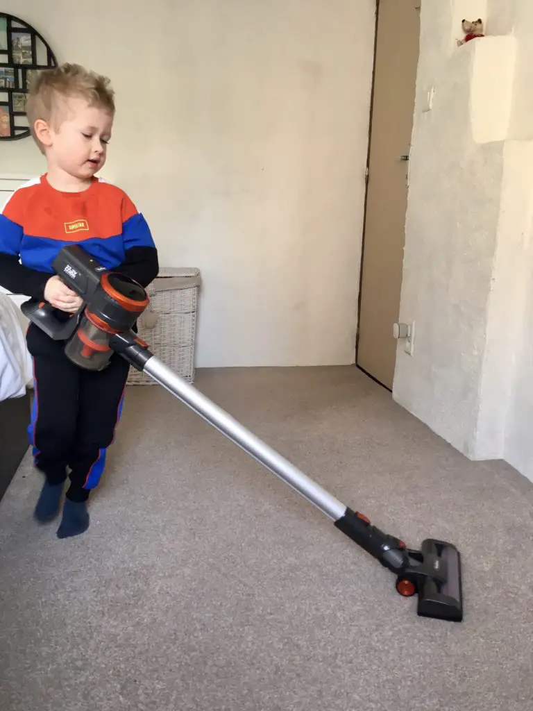 Lucas using the Vonhaus handheld vacuum