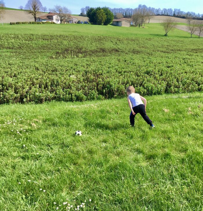 Lucas playing football in the garden