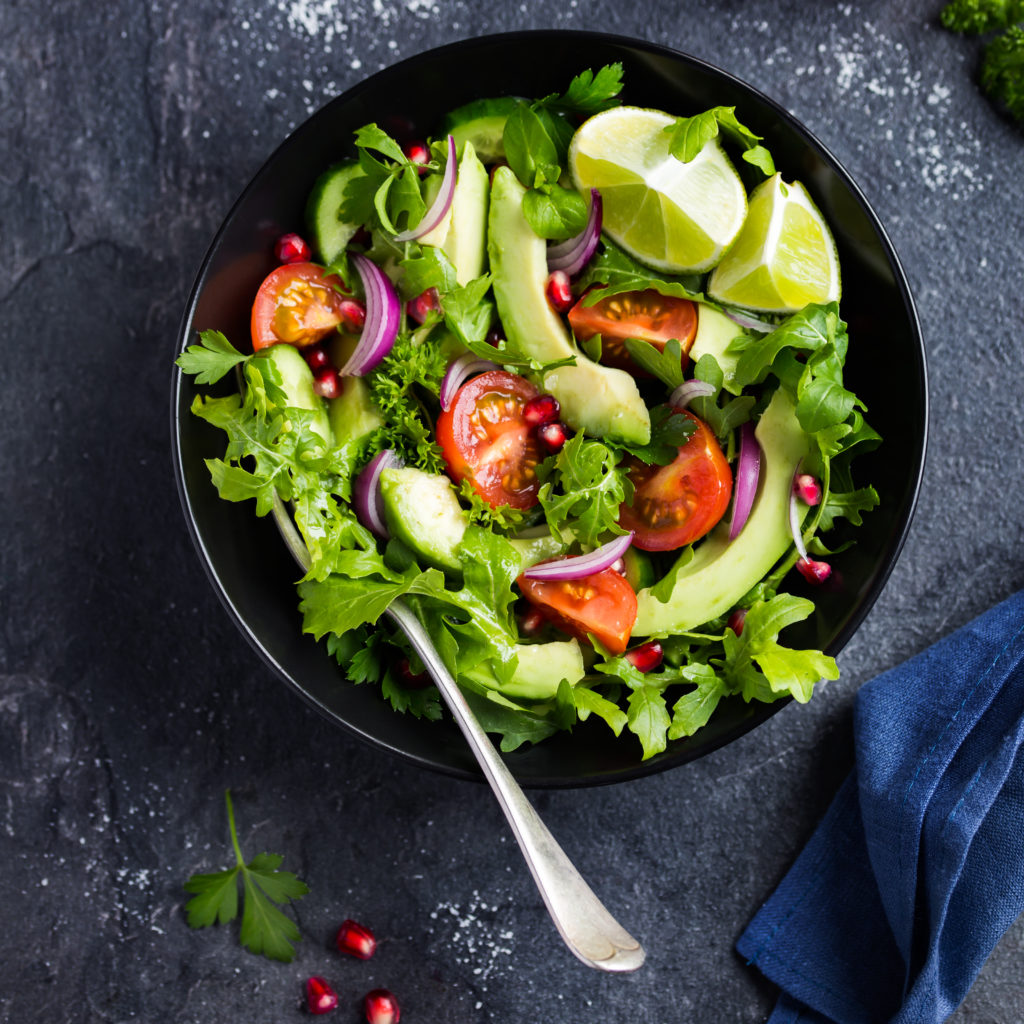 avocado, tomato and arugula salad. Healthy vegan food. Top view, square image