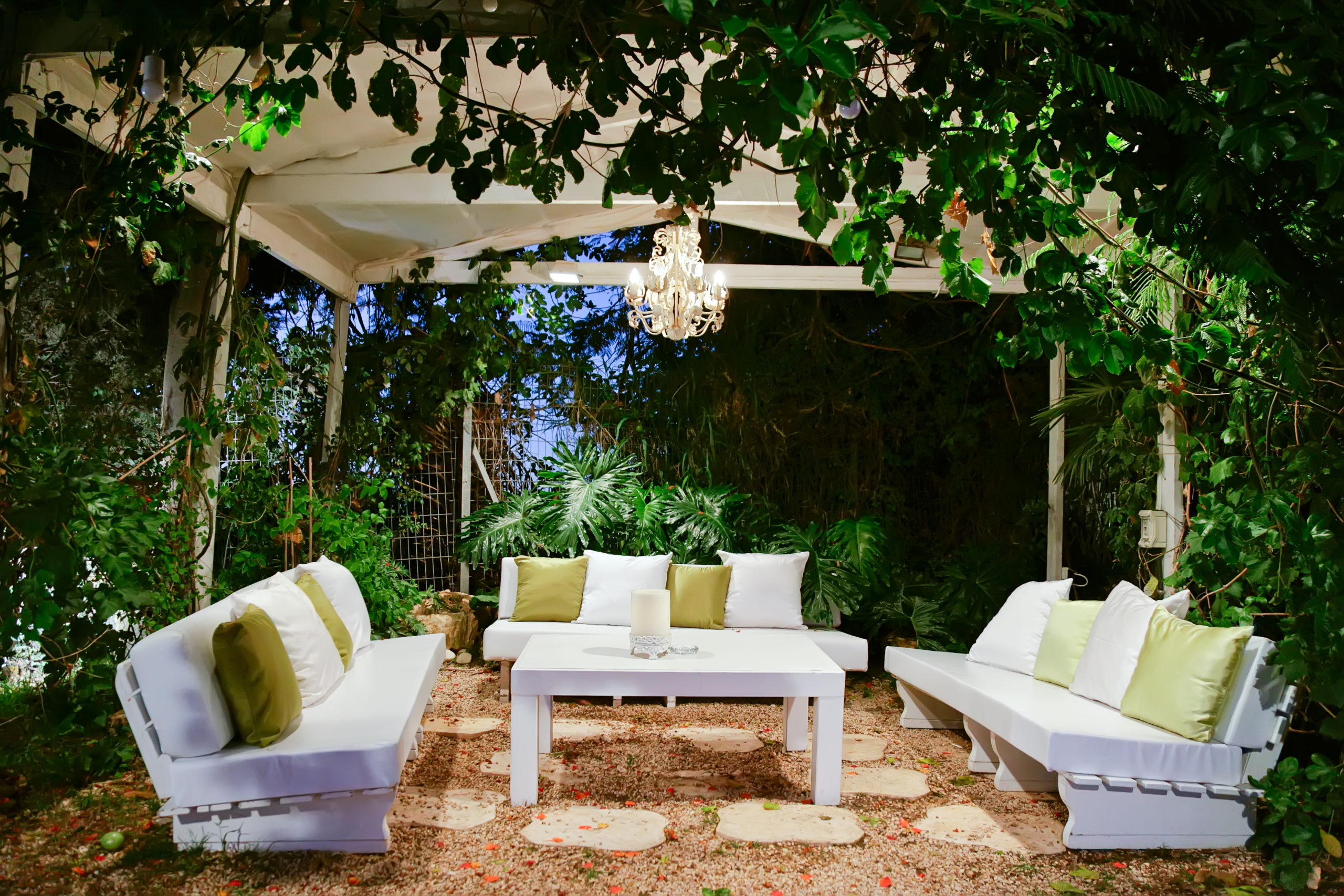 garden lighting with patio romantic in the evening with benches and pillows chandelier and table
