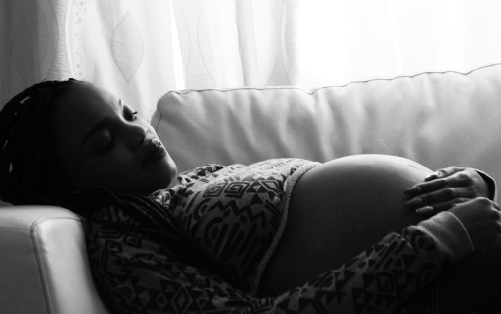 Pregnant woman lay down on sofa