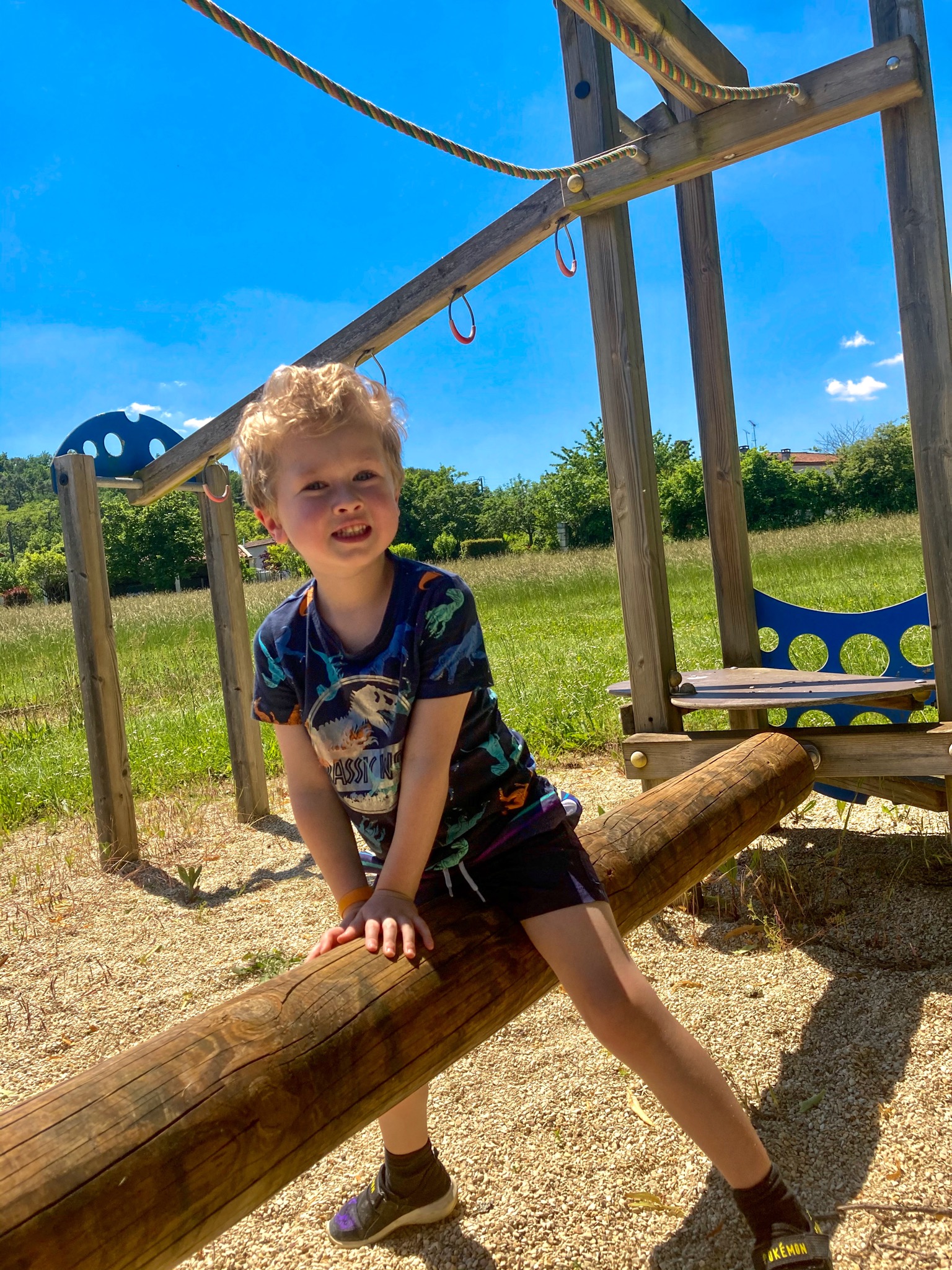 Lucas sat on play equipment in the play area