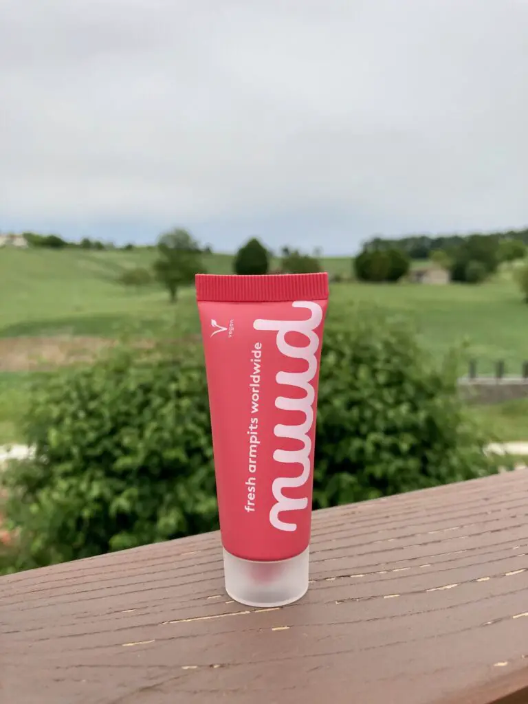 The pink nuud tube outside on a fence with countryside in the background 