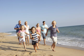 Portrait Of Three Generation Family On Beach Holiday