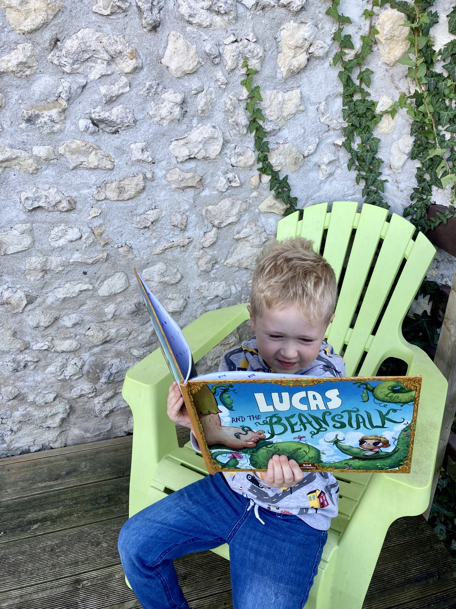 Lucas sat reading Lucas and the Beanstalk book
