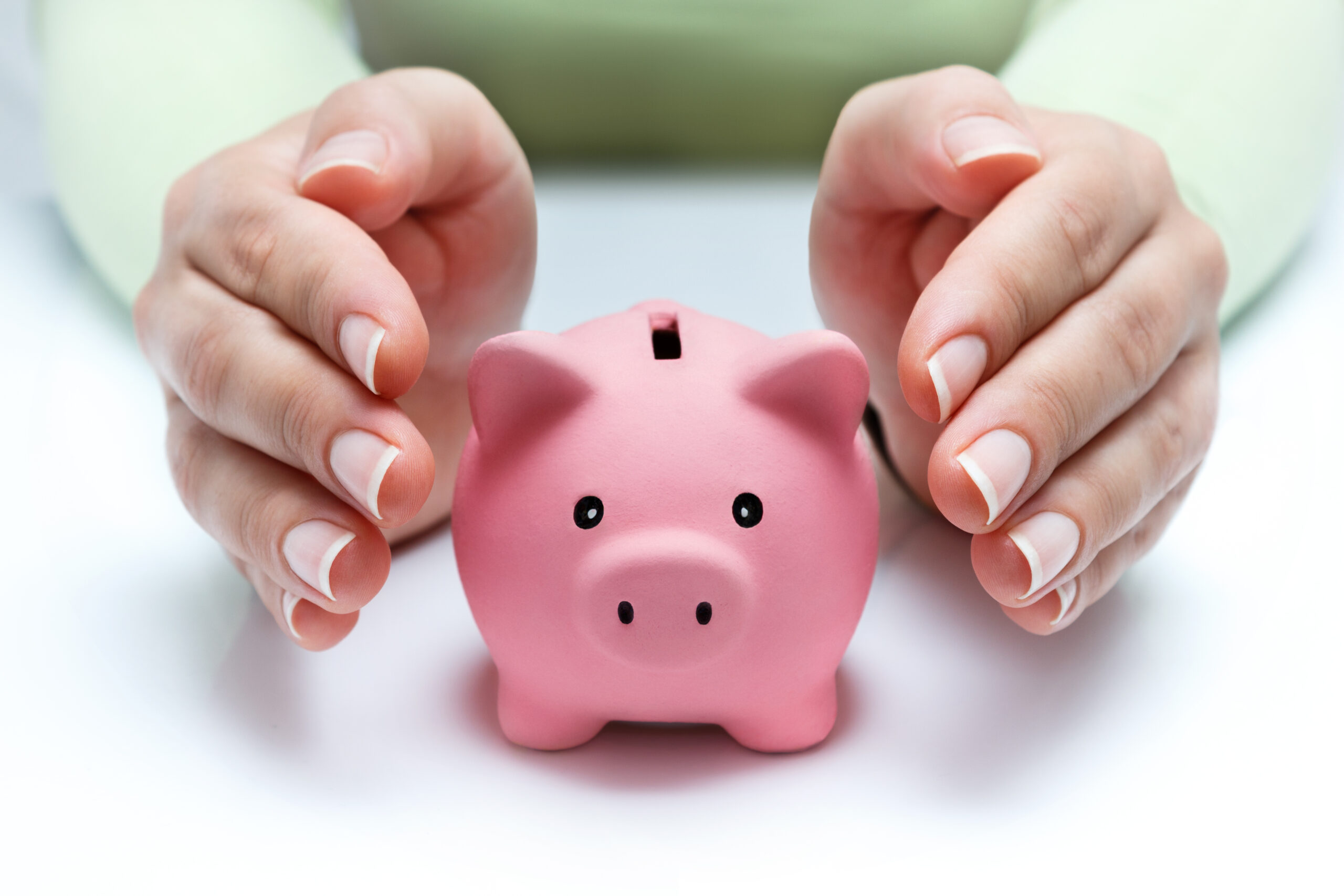 a piggy bank with hands around it