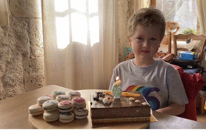 Lucas with a choc cake and macaroons 