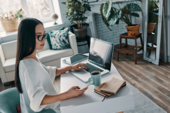 a lady on a laptop in a home office environment