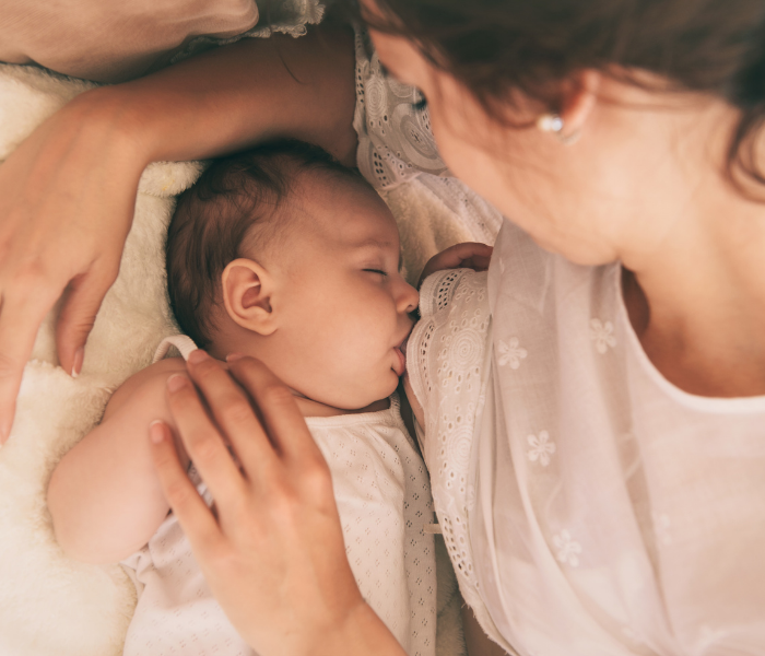 a woman breastfeeding a baby