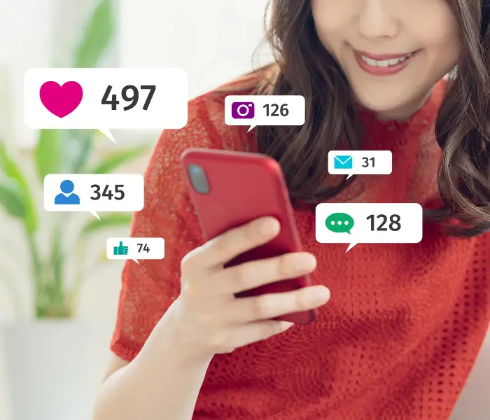 influencer holding phone with likes and message count symbols showing