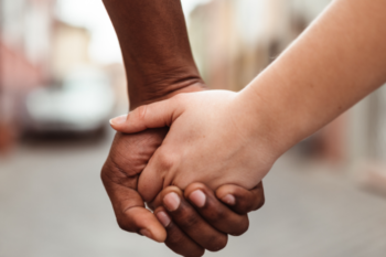 two adults holding hands