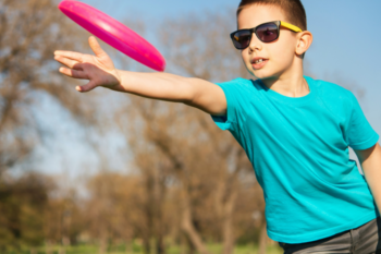 boy throwing frisbee