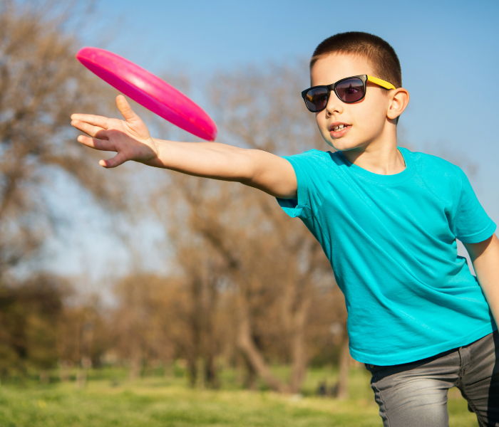 boy throwing frisbee