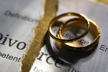 2 wedding rings on ripped up divorce paper